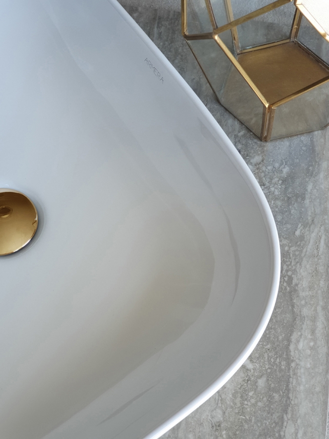 Curved linear counter top bowl, brushed gold waste.