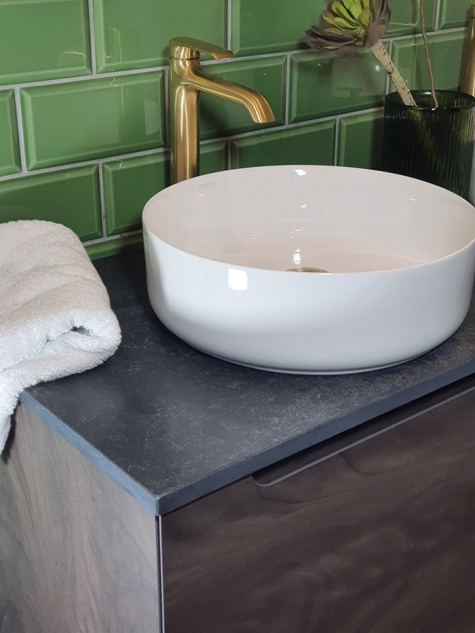 1200mm Atoll unit in walnut noir, round bowl on tempest black counter top, Vaere extended single lever monobasin mixer in brushed gold and co-ordinating brushed gold click clack waste.