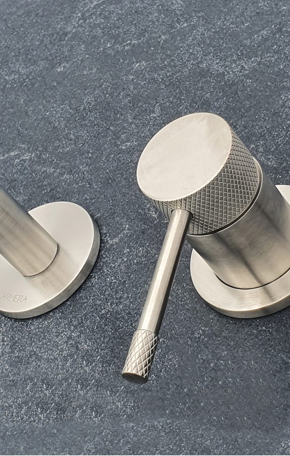 Maze wall mounted basin mixer in brushed stainless steel.